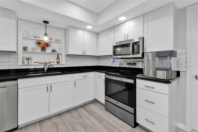 kitchen featuring stainless steel appliances and white cabinets