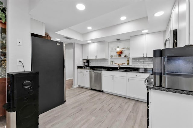 kitchen with white cabinetry, light wood-type flooring, a raised ceiling, and stainless steel dishwasher