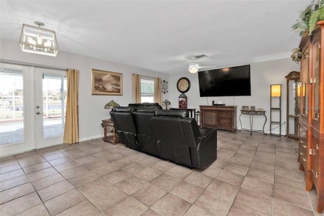 tiled living room featuring french doors, plenty of natural light, and ceiling fan