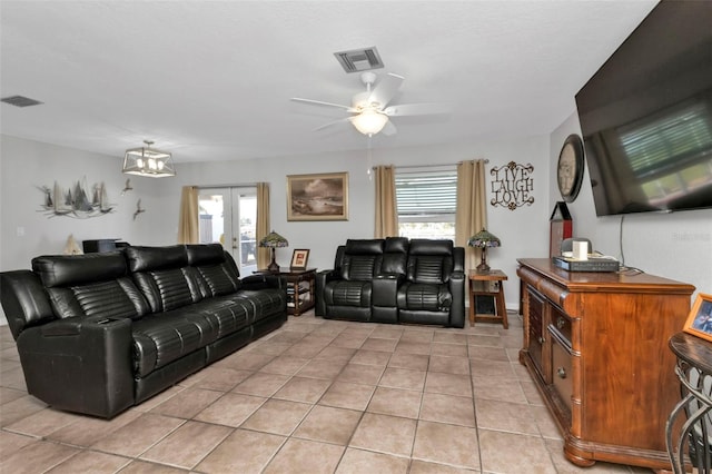 living room with french doors, ceiling fan, light tile patterned flooring, and a wealth of natural light