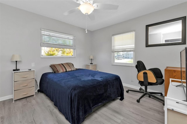 bedroom with ceiling fan and light hardwood / wood-style flooring