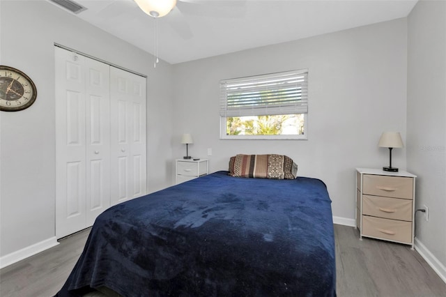 bedroom featuring hardwood / wood-style floors, a closet, and ceiling fan