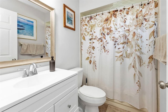 bathroom featuring toilet, vanity, tile patterned floors, and a shower with shower curtain