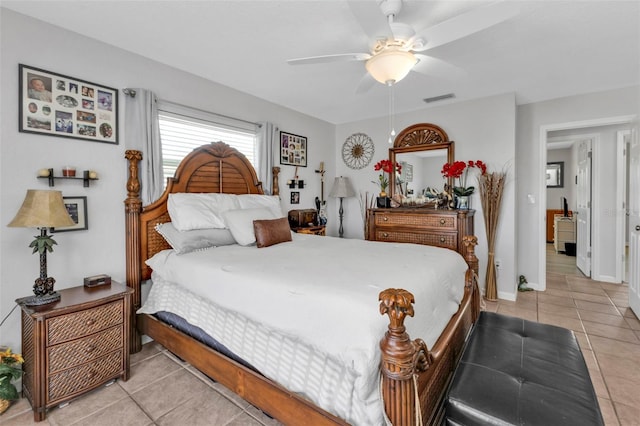 tiled bedroom featuring ceiling fan