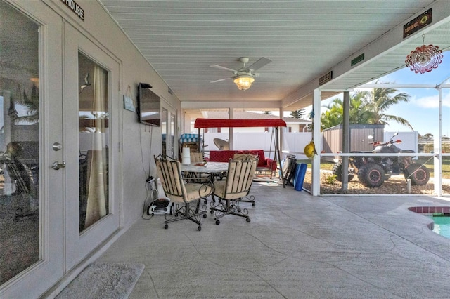 view of patio featuring a lanai and ceiling fan