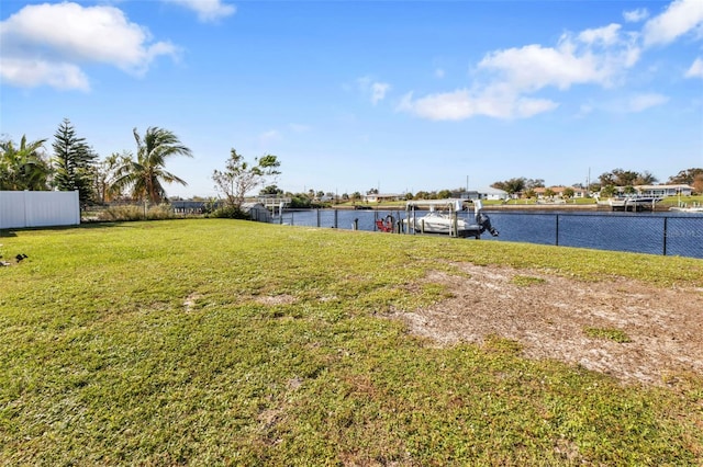 view of yard with a dock and a water view