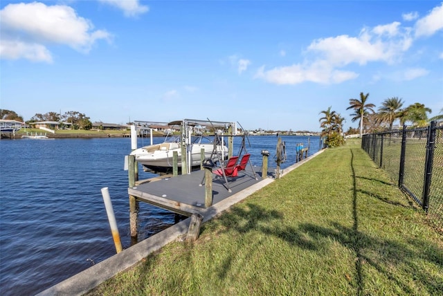 dock area with a water view and a lawn