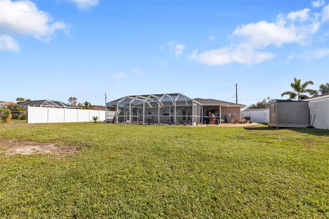 back of house featuring a lanai and a lawn