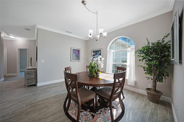 dining area featuring a chandelier and ornamental molding