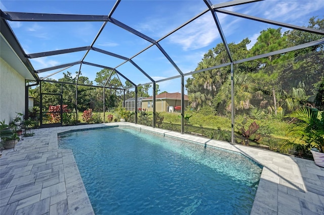 view of pool with a patio and a lanai