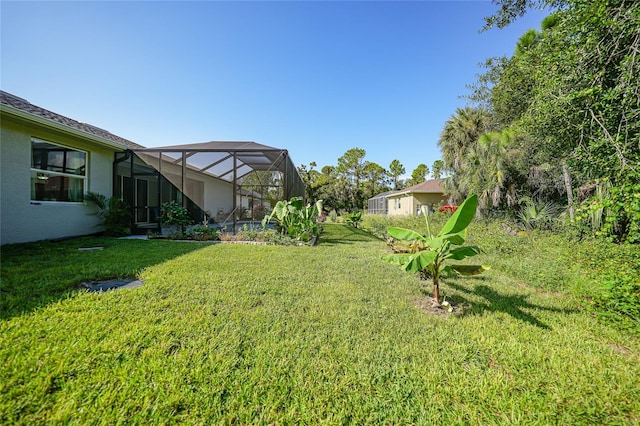 view of yard featuring glass enclosure