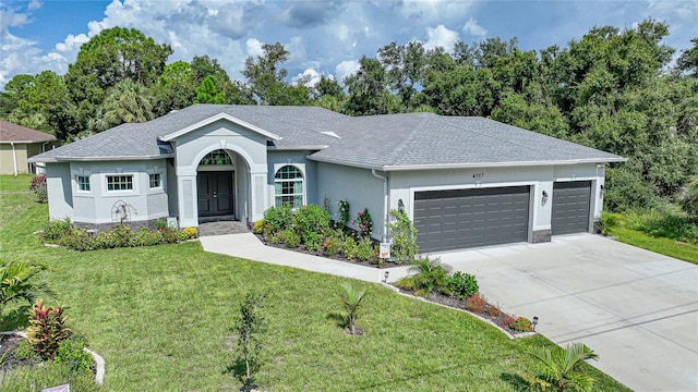 ranch-style home with a garage and a front lawn