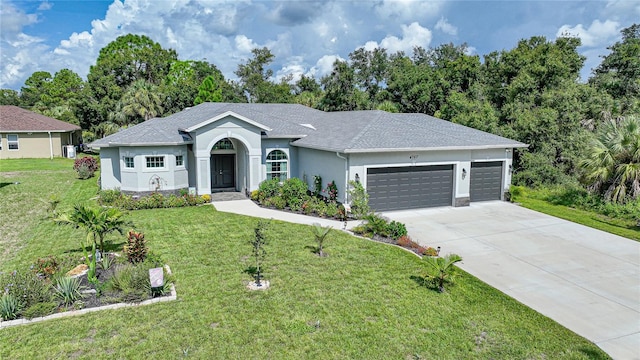 ranch-style house featuring a garage and a front yard