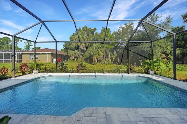 view of pool with glass enclosure