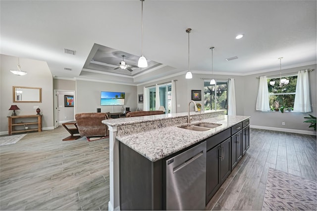 kitchen featuring dishwasher, ceiling fan with notable chandelier, sink, and decorative light fixtures