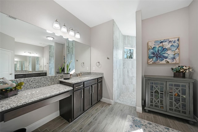 bathroom with a shower and vanity