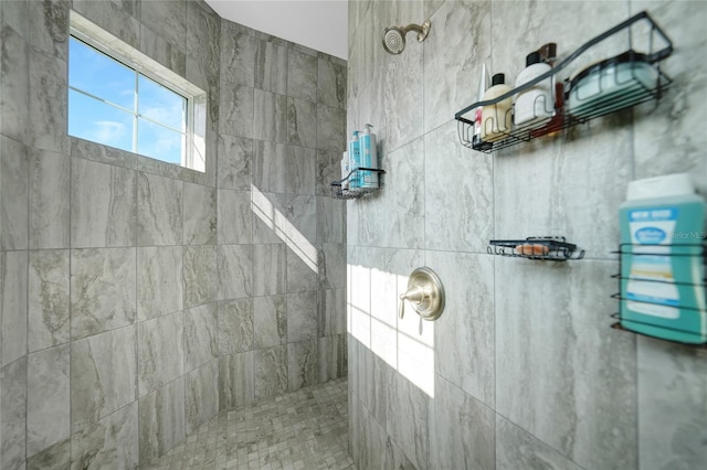 bathroom with a tile shower