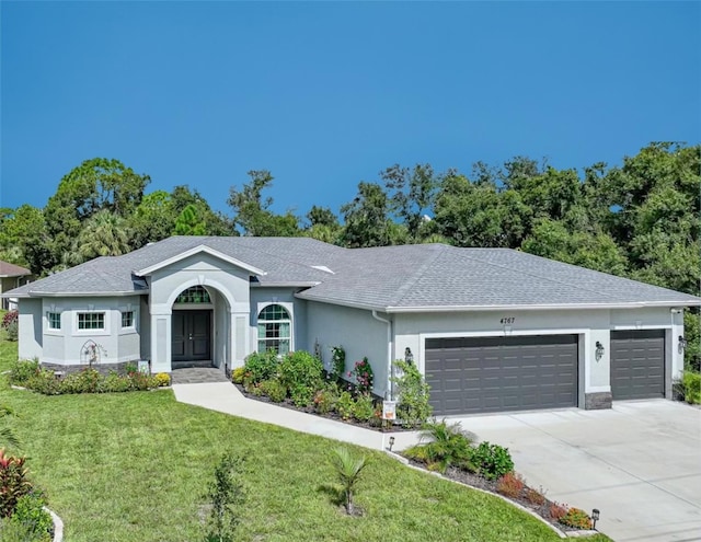 ranch-style home featuring a garage and a front yard