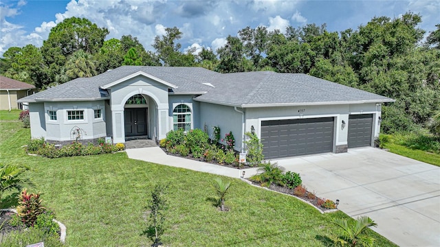 ranch-style house with a garage, driveway, roof with shingles, stucco siding, and a front yard