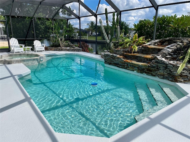 view of pool with glass enclosure and an in ground hot tub