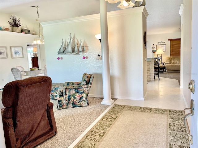 interior space featuring tile patterned flooring, decorative columns, an inviting chandelier, and ornamental molding