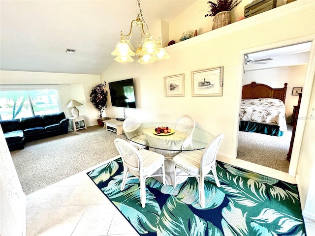 carpeted dining room with ceiling fan with notable chandelier and vaulted ceiling