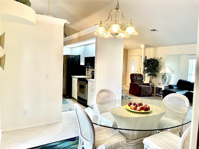 dining space with a chandelier and light tile patterned floors