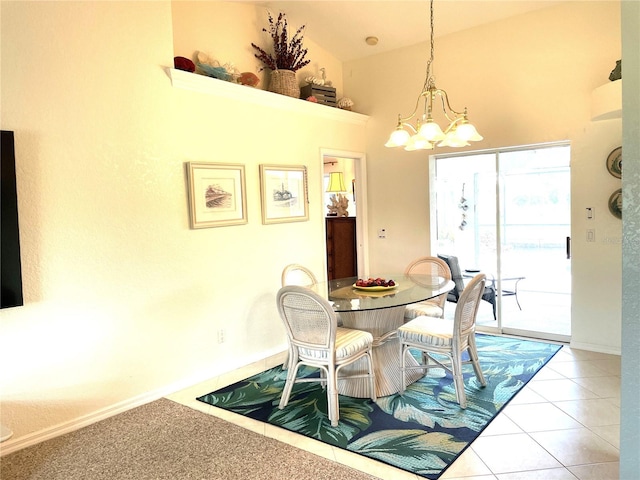 tiled dining area with high vaulted ceiling and an inviting chandelier