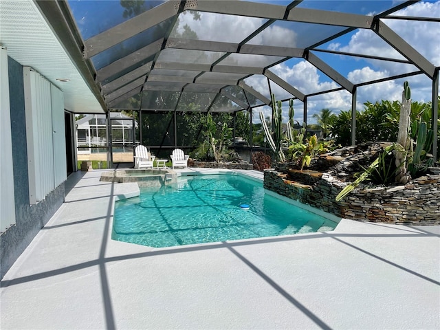 view of swimming pool with a lanai and a patio area