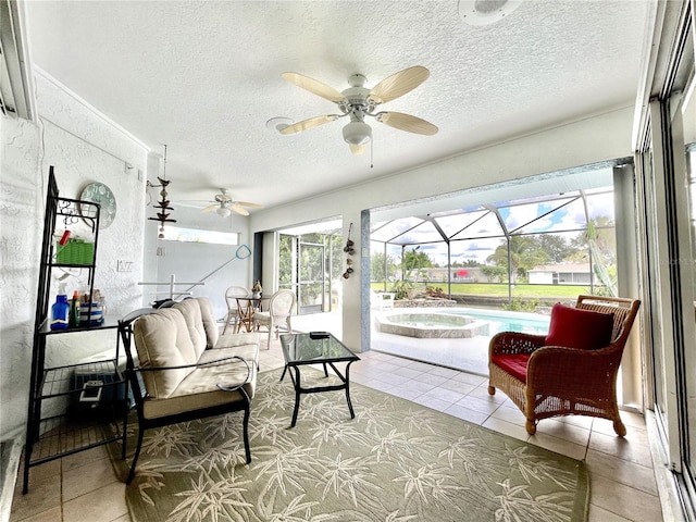 sunroom / solarium featuring ceiling fan, a pool, and a wealth of natural light