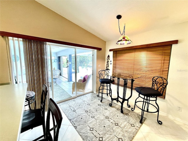 dining room with light tile patterned flooring and lofted ceiling