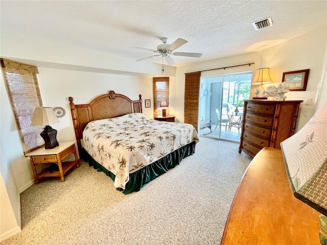 carpeted bedroom featuring access to exterior, a textured ceiling, and ceiling fan