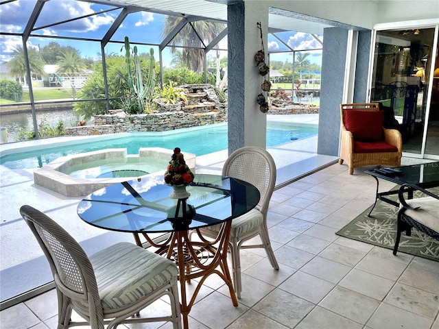 view of pool with glass enclosure, an in ground hot tub, a water view, and a patio