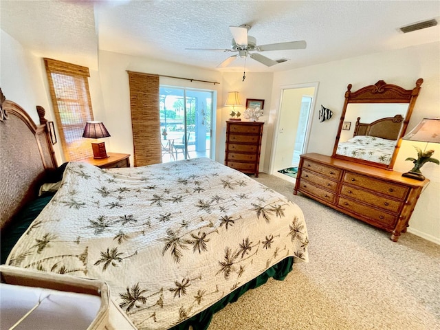 carpeted bedroom with ceiling fan, a textured ceiling, and access to outside