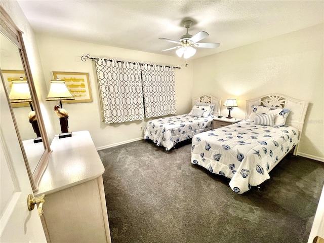 bedroom featuring ceiling fan, dark carpet, and a textured ceiling