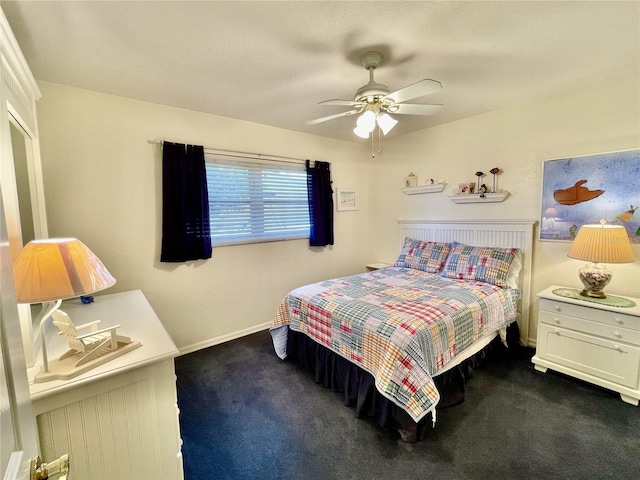 bedroom featuring dark colored carpet and ceiling fan