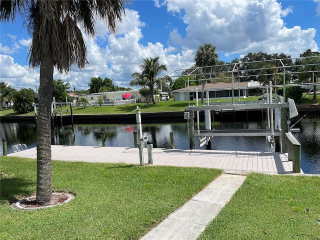 view of dock featuring a water view and a lawn