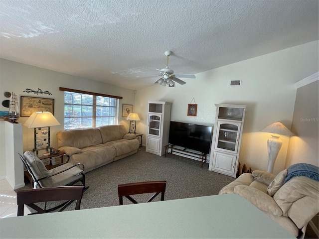 living room with carpet flooring, a textured ceiling, and ceiling fan