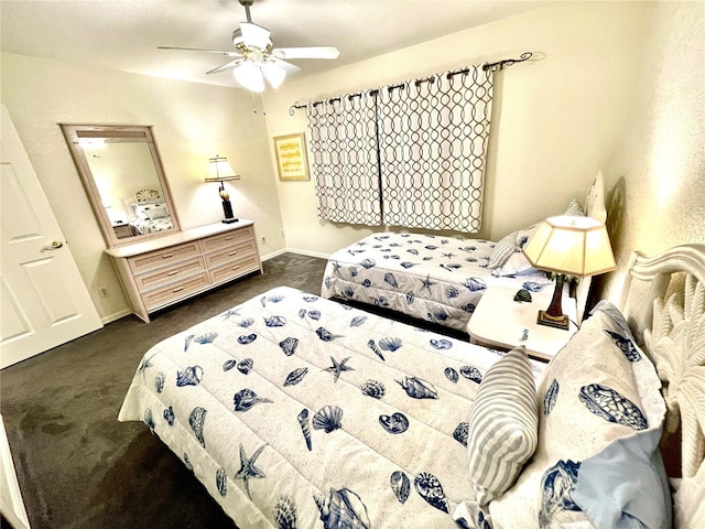 bedroom with ceiling fan and dark colored carpet