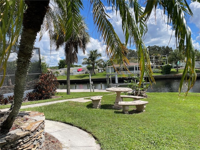 view of property's community featuring a yard and a water view