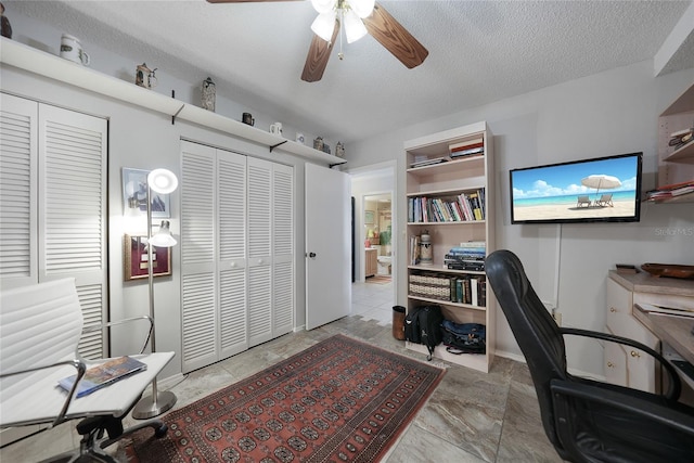 office area featuring a textured ceiling and ceiling fan