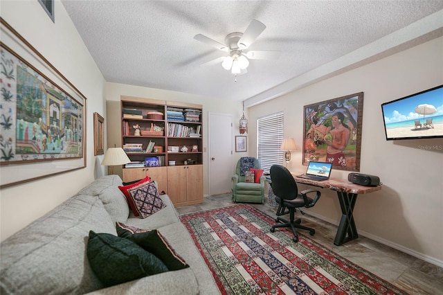 office featuring a textured ceiling and ceiling fan