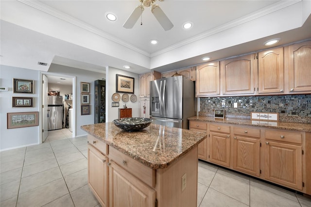 kitchen featuring light stone counters, stainless steel fridge with ice dispenser, a kitchen island, decorative backsplash, and crown molding