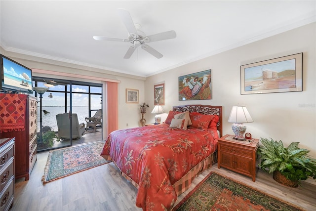 bedroom with a water view, ornamental molding, ceiling fan, and access to exterior