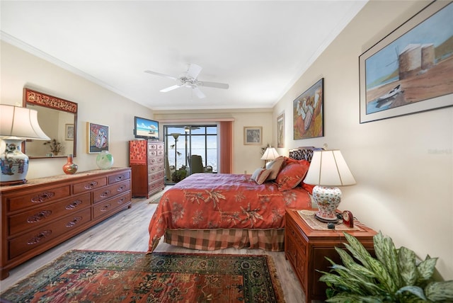 bedroom featuring ornamental molding, light hardwood / wood-style floors, and ceiling fan