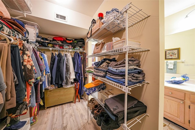 spacious closet with light hardwood / wood-style floors