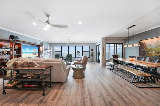 living room featuring ornamental molding, ceiling fan, and hardwood / wood-style flooring