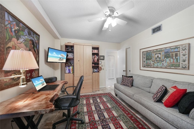 office featuring ceiling fan and a textured ceiling