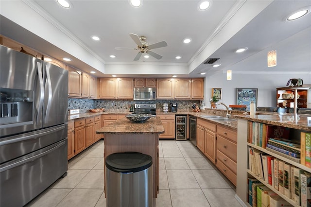 kitchen featuring appliances with stainless steel finishes, ornamental molding, sink, and light tile patterned floors