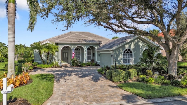 mediterranean / spanish-style house with a garage